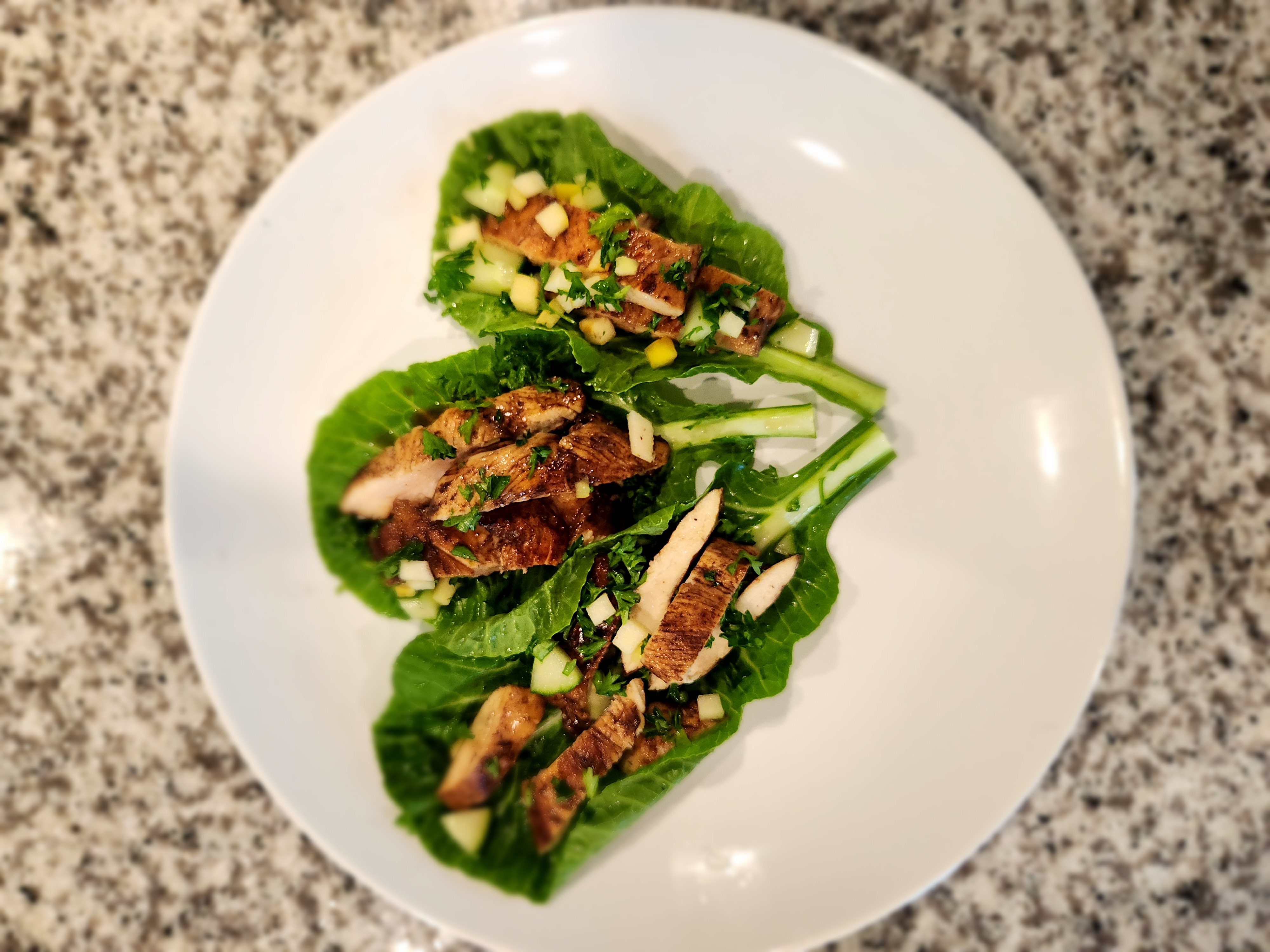 Spiced chicken in collard green wraps with apple herb salsa