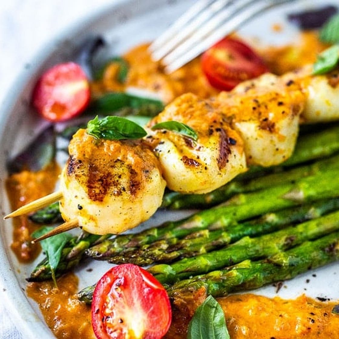 Grilled scallops with roasted tomato vinaigrette and fresh basil