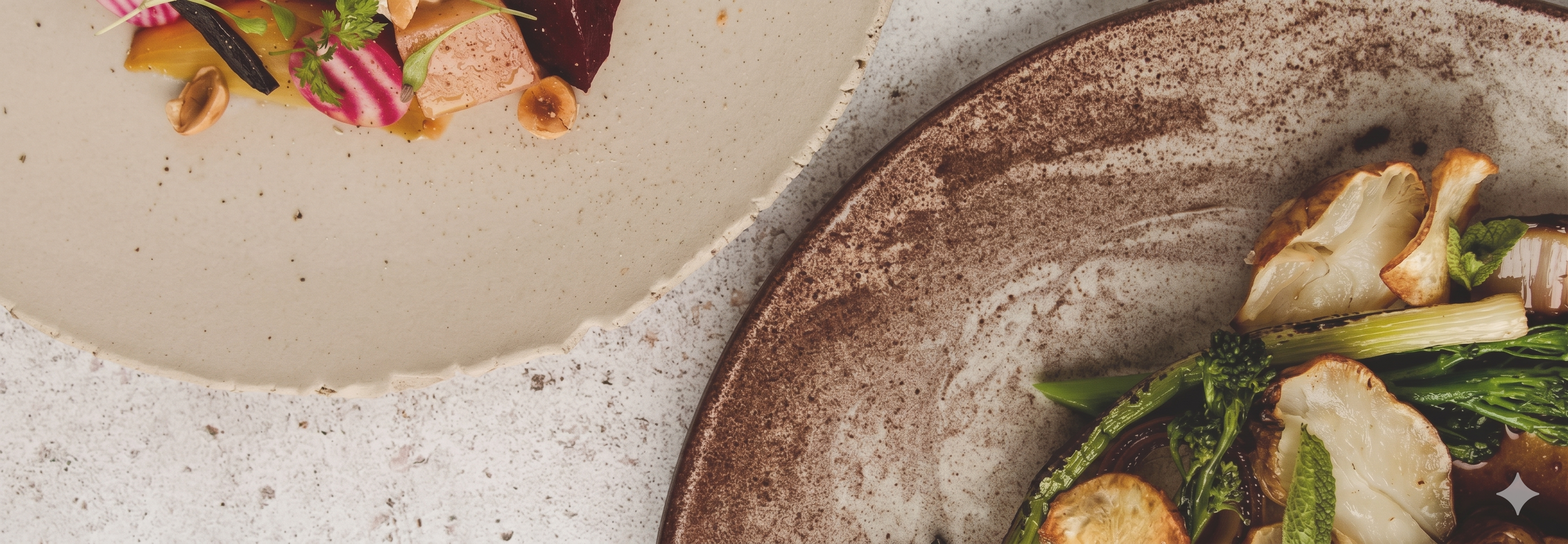 Two artfully plated courses — roasted salmon with beets and hazelnuts alongside seared cauliflower with asparagus