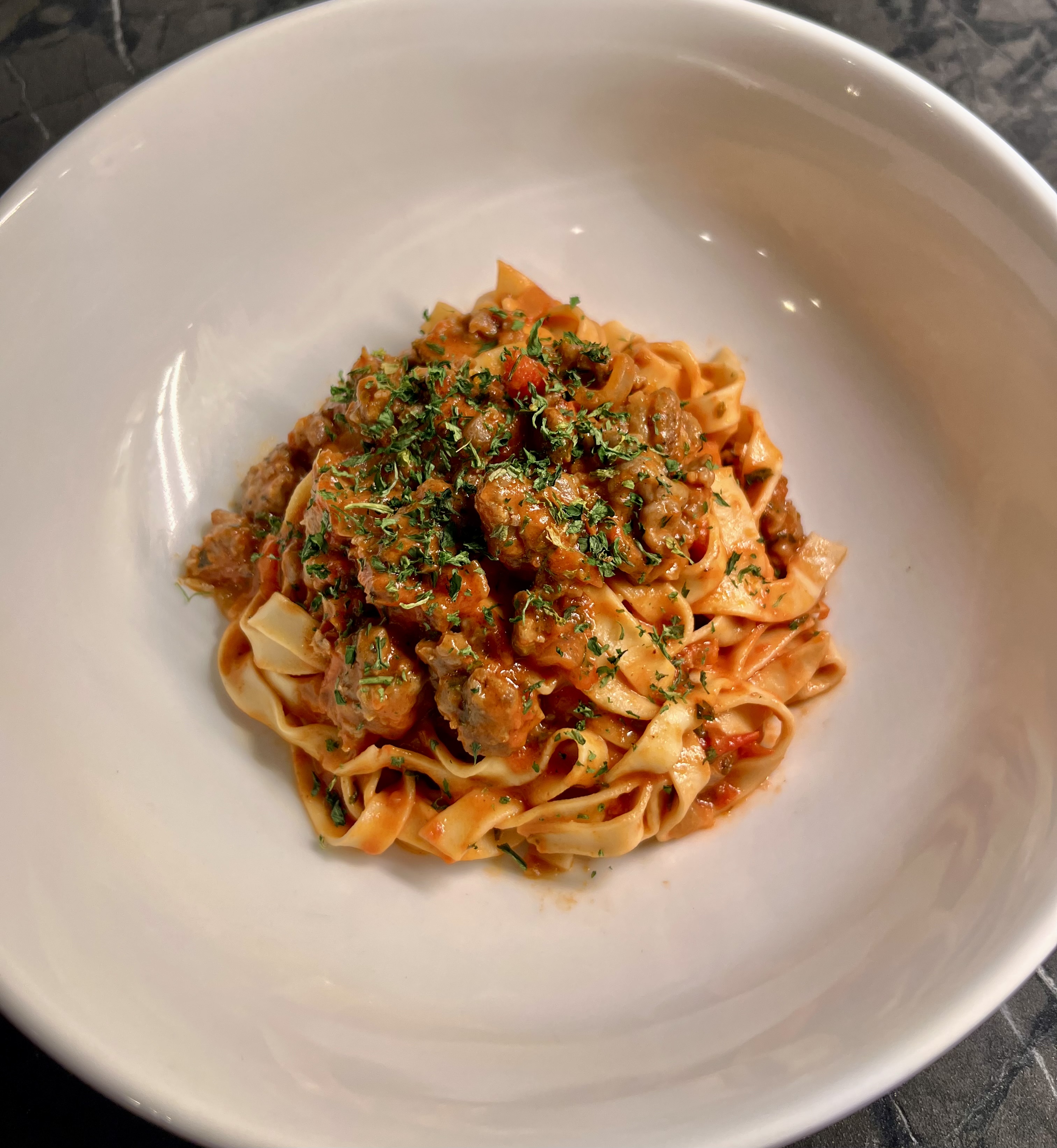 Tagliatelle with slow-braised meat ragu and fresh herbs